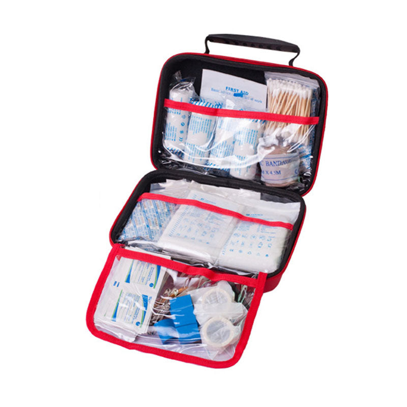 Open first aid kit with various supplies on a white background